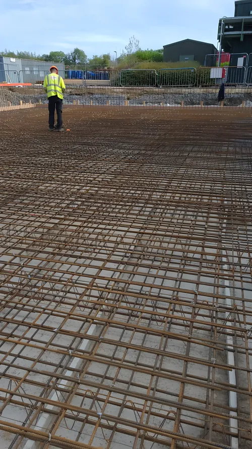 Steel reinforcement mesh laid across a large floor area before the pour.