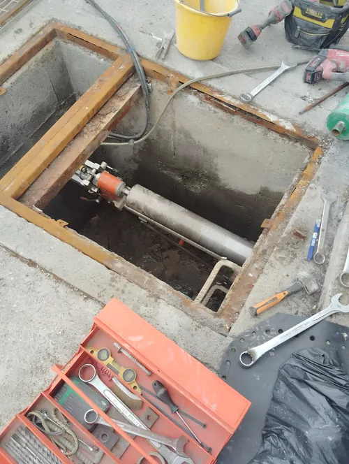 Coring through the wall of a concrete pit below floor level.