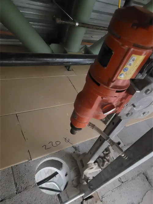 Coring through a wall for a ventilation opening.