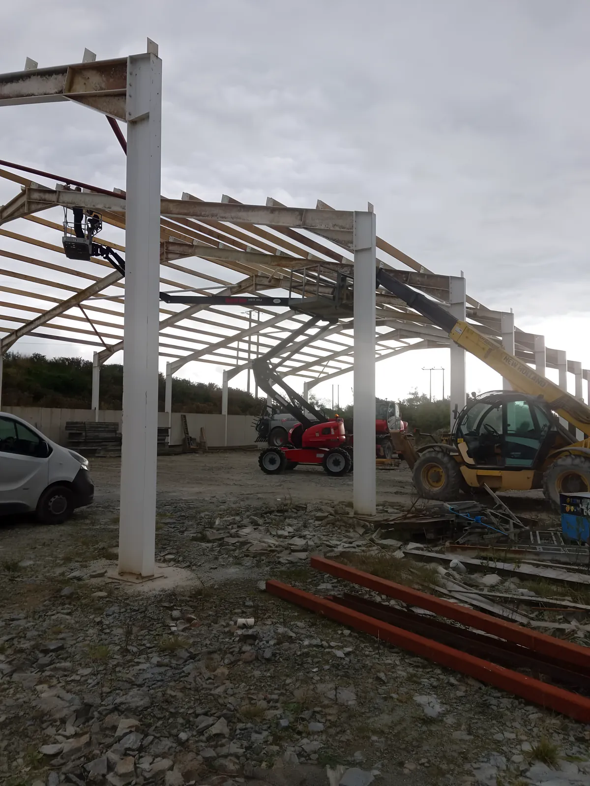 Steel frame of a shed going up, with a teleporter lifting beside it.
