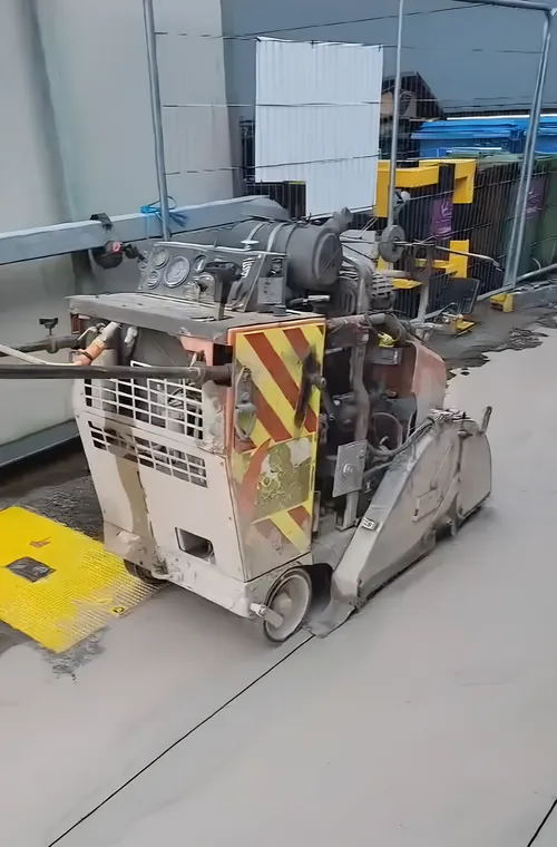 Diesel floor saw on a concrete floor slab.