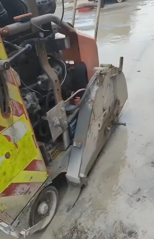 Floor saw part way through a cut in a concrete slab, water-cooled.