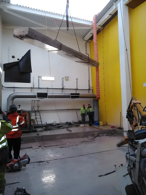 Beam lifted out during demolition work inside an industrial unit.