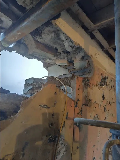 Opening broken out of an old stone wall, with temporary support in place above.