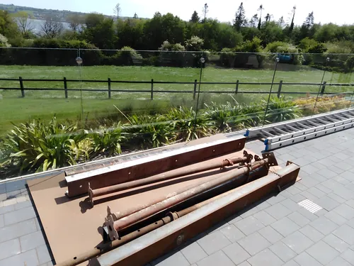 Props and steel beams laid out on a patio, ready to go in.