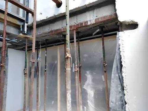 Rows of adjustable props carrying a concrete slab during the works.