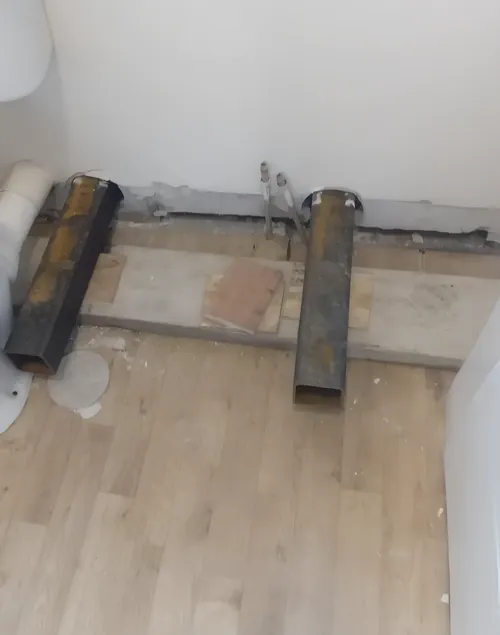 Two steel sections set through the base of an internal wall.